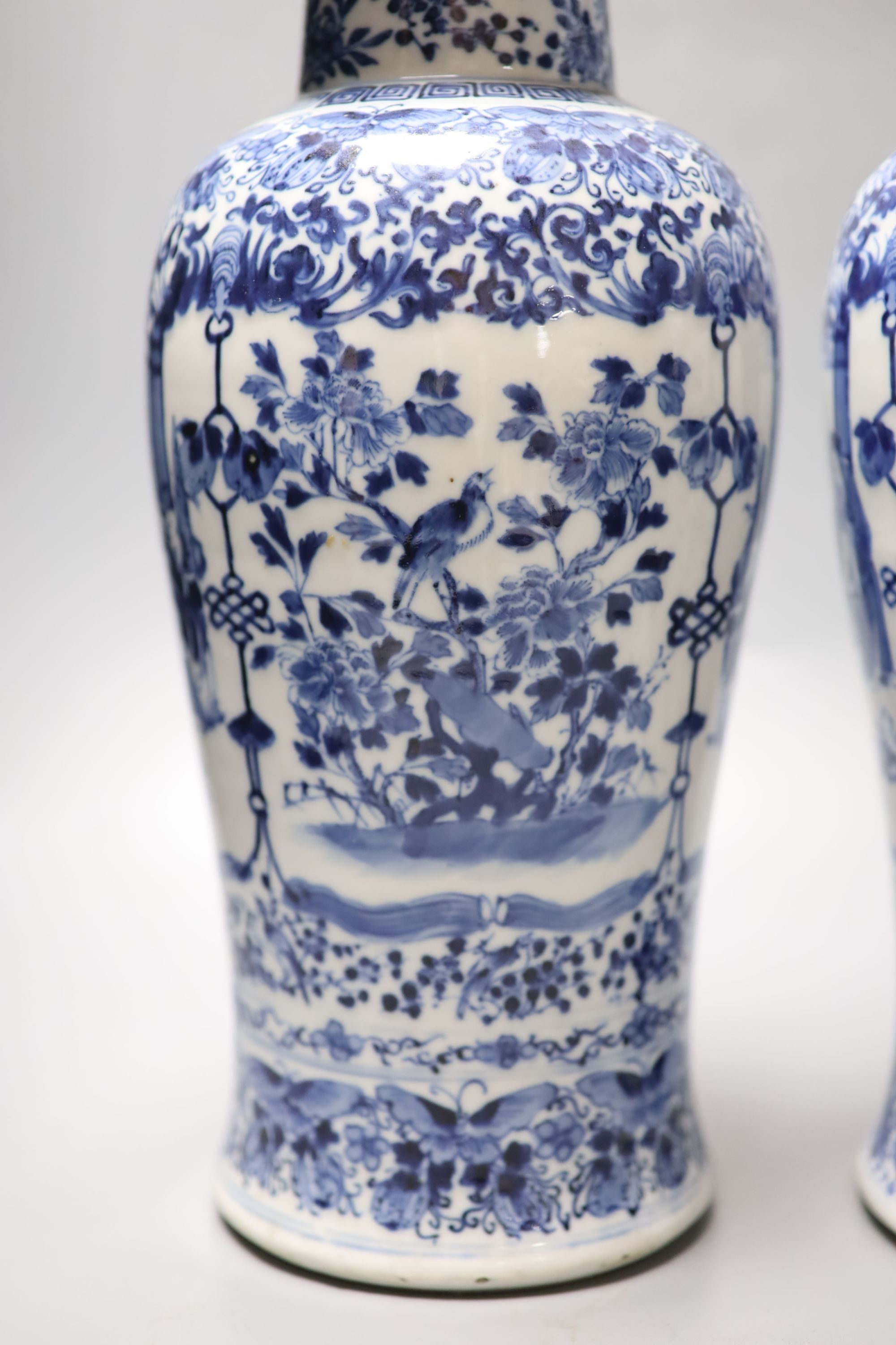 A pair of Chinese blue and white baluster vases and covers, Kangxi marks, late 19th century, 39.5cm high